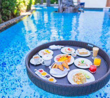 Floating breakfast set tray with fried egg omelette sausage ham bread fruit milk juice coffee 1 360x320