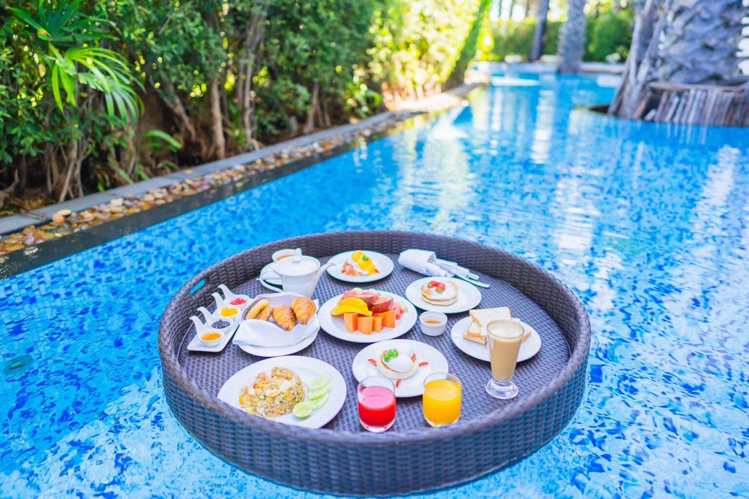 Floating breakfast set tray with fried egg omelette sausage ham bread fruit milk juice coffee 1536x1024